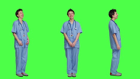 Cheerful-smiling-medical-assistant-standing-against-greenscreen-backdrop